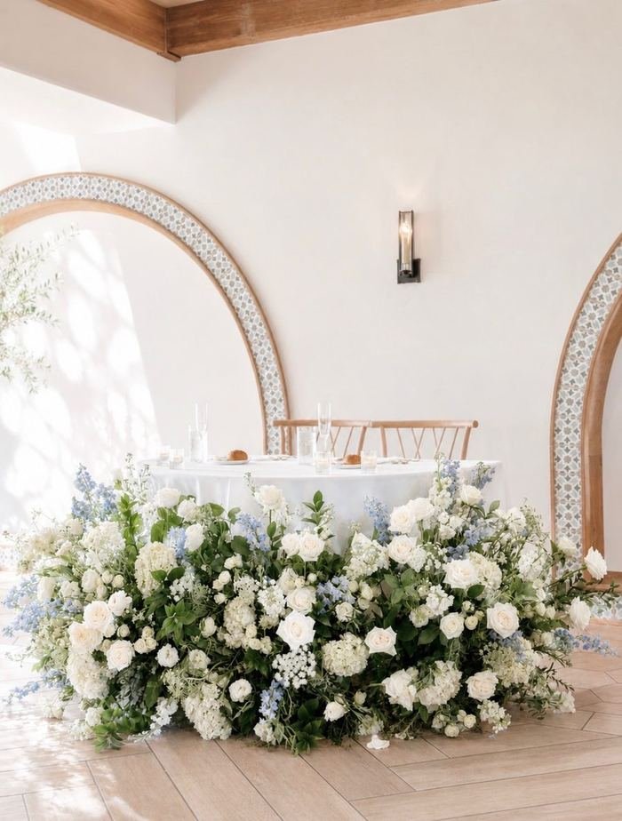 Wedding sweetheart table with white and blue floral arrangement at Agape 1928